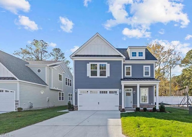 view of front of home featuring a garage, a standing seam roof, a front yard, and board and batten siding