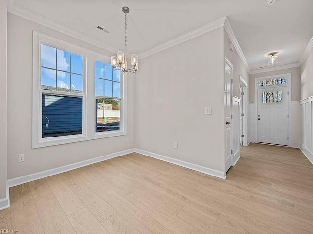 interior space featuring light wood-type flooring, an inviting chandelier, visible vents, and ornamental molding