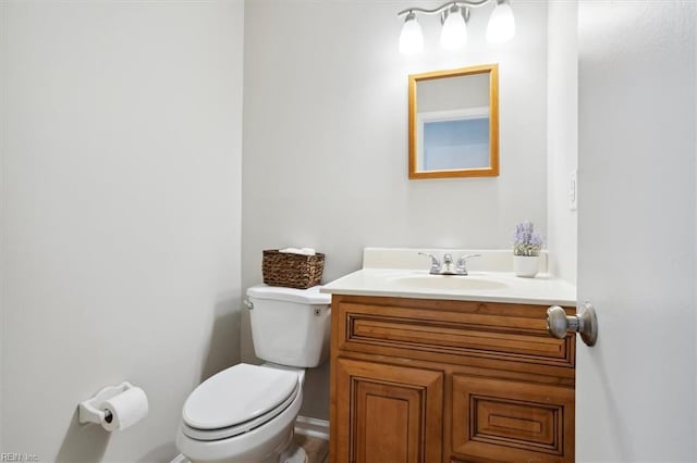 bathroom featuring toilet and vanity