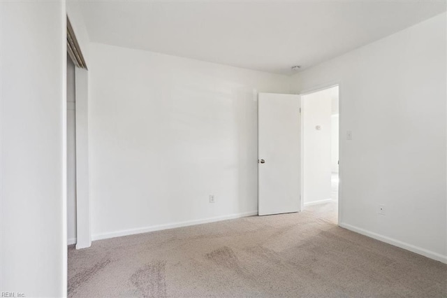 carpeted spare room with baseboards