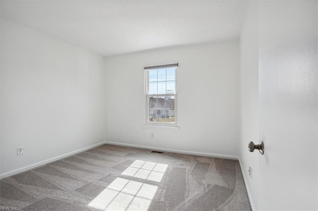 carpeted empty room with visible vents and baseboards