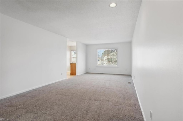 carpeted spare room with baseboards