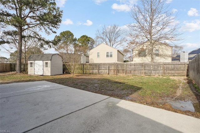 view of yard featuring a fenced backyard, a storage unit, a patio, and an outdoor structure