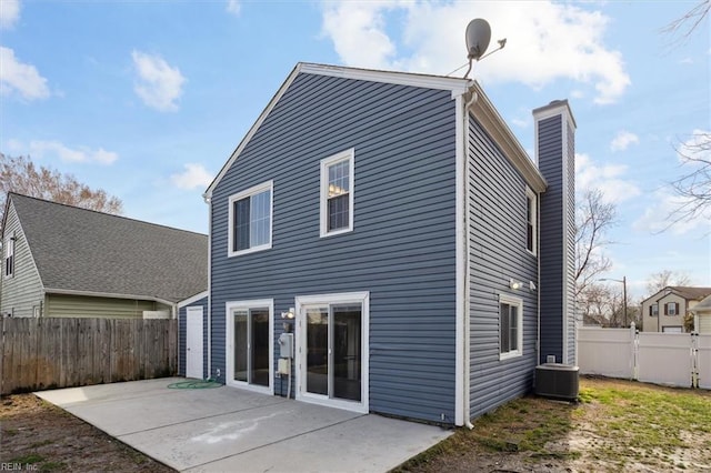 rear view of house featuring central AC, a chimney, a patio area, and a fenced backyard