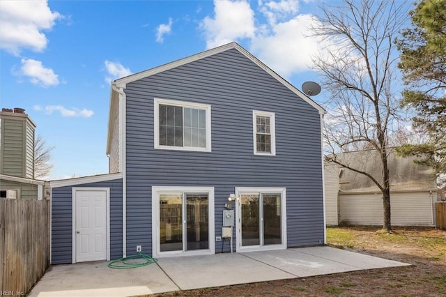 back of property featuring a patio area and fence