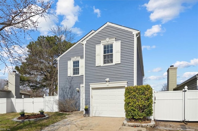 view of property exterior with a gate, fence, driveway, and an attached garage