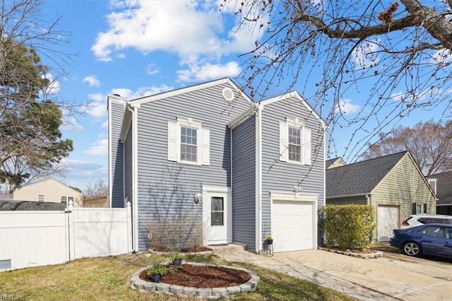 traditional home featuring fence, driveway, and an attached garage