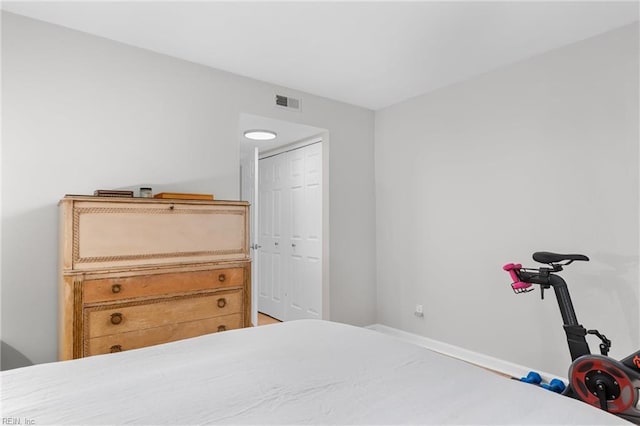 bedroom with a closet and visible vents