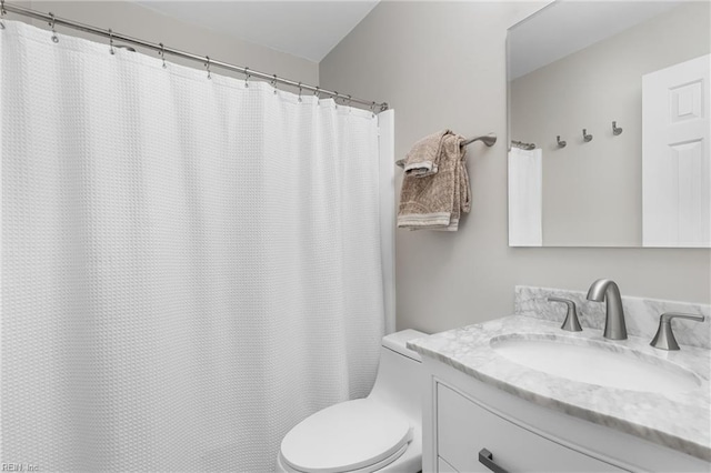 full bathroom featuring vanity and toilet