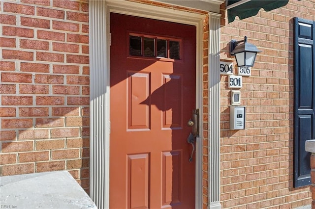 property entrance with brick siding