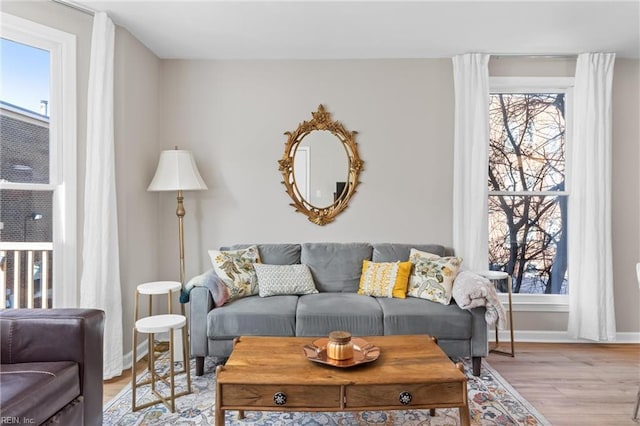 living room with baseboards and light wood-style floors