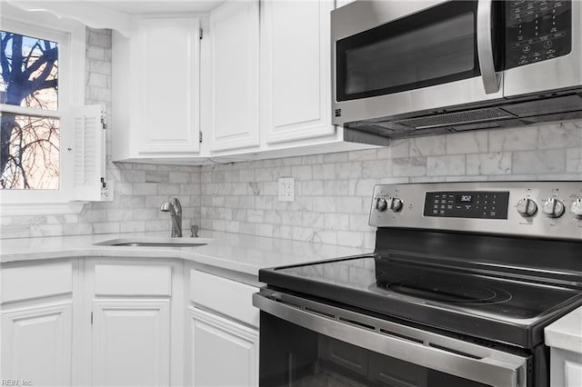 kitchen featuring a healthy amount of sunlight, appliances with stainless steel finishes, and light countertops