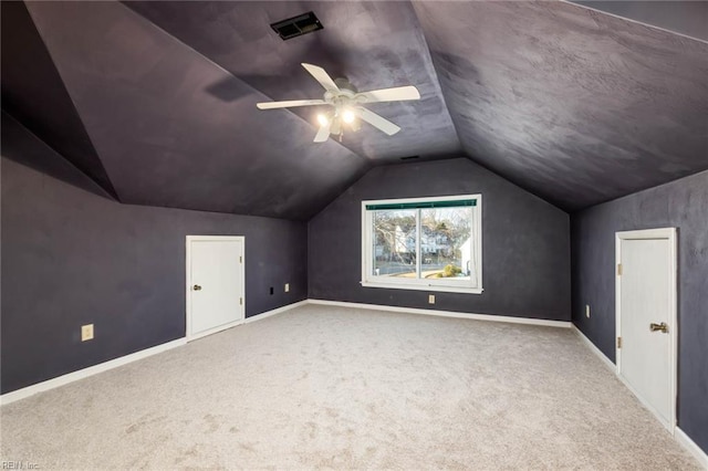 bonus room with lofted ceiling, ceiling fan, visible vents, baseboards, and carpet