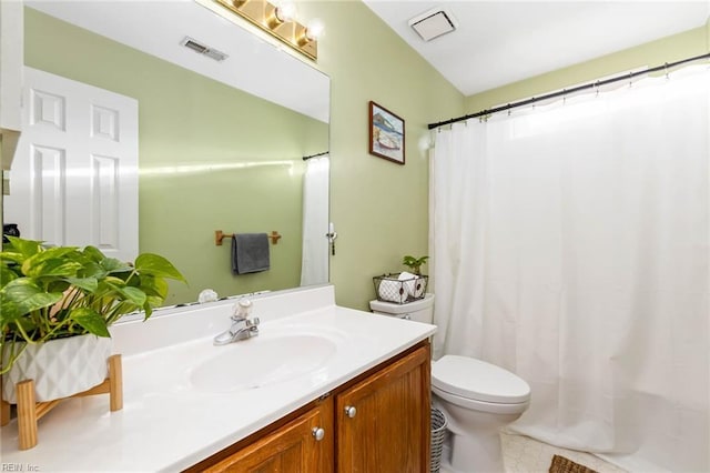 bathroom featuring toilet, a shower with curtain, visible vents, and vanity