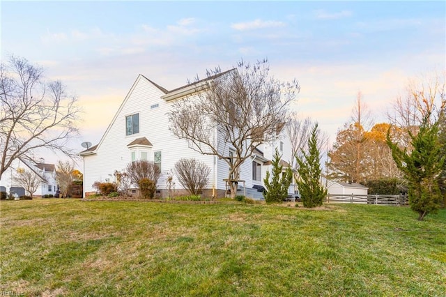 view of side of home featuring crawl space, a yard, and fence