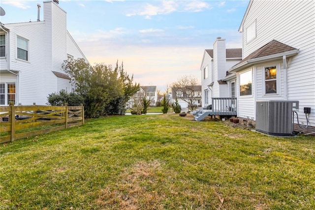 view of yard with fence and central AC