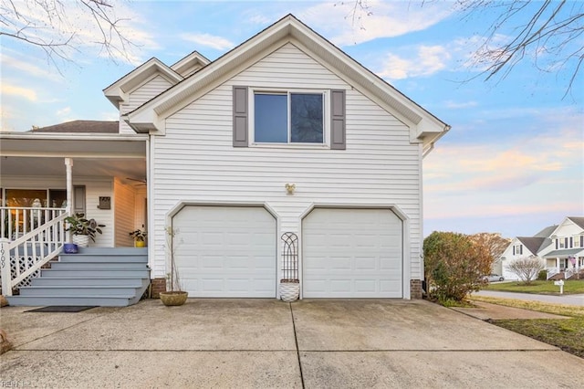 view of property exterior featuring driveway, a porch, and an attached garage