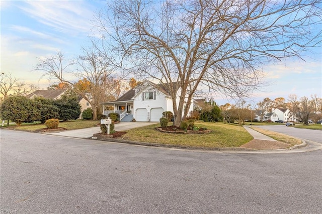 view of front of home with a garage, a front lawn, and concrete driveway