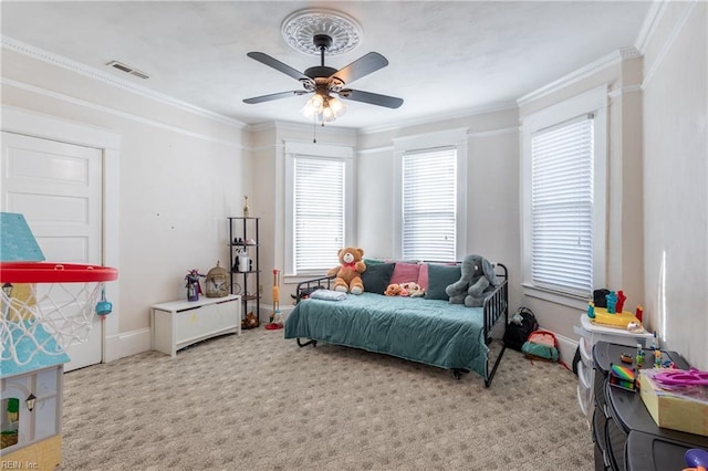 bedroom with light carpet, a ceiling fan, baseboards, visible vents, and crown molding