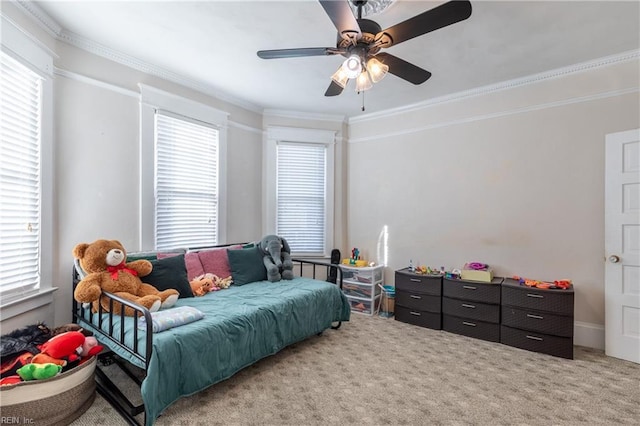 bedroom featuring ornamental molding, light colored carpet, and a ceiling fan