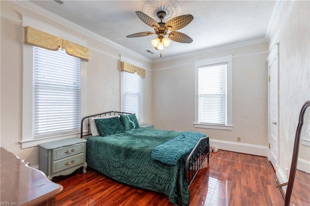 bedroom featuring crown molding, multiple windows, and dark wood finished floors