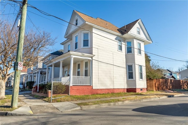 view of home's exterior with crawl space, covered porch, and fence