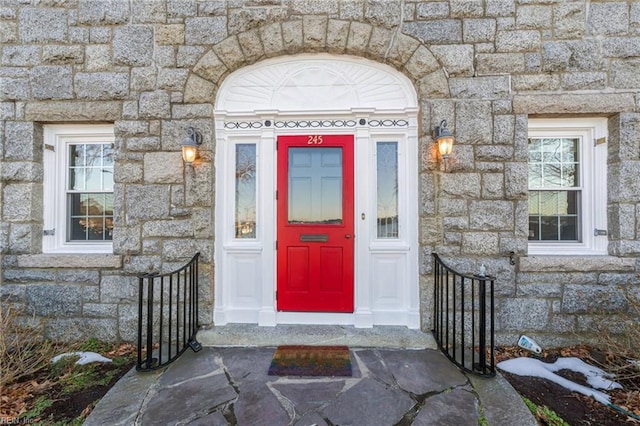 doorway to property with stone siding