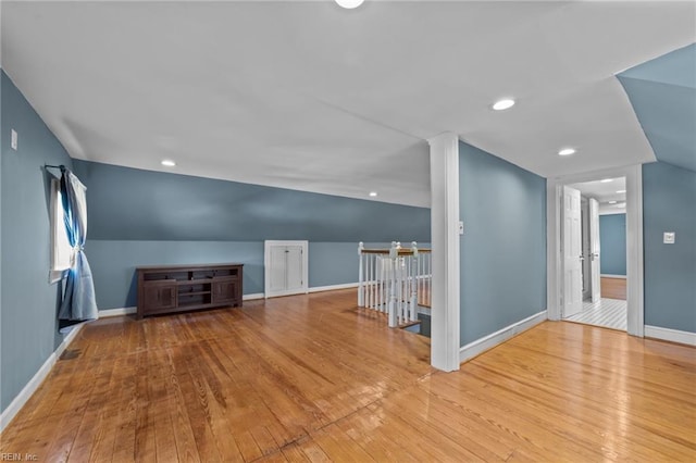 additional living space featuring recessed lighting, baseboards, vaulted ceiling, and hardwood / wood-style floors