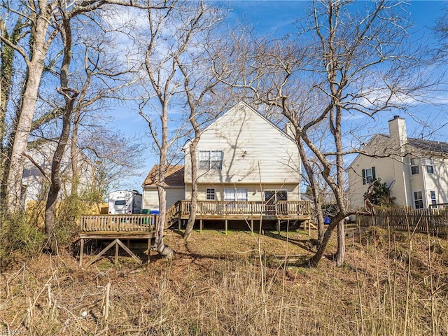 rear view of property featuring a deck