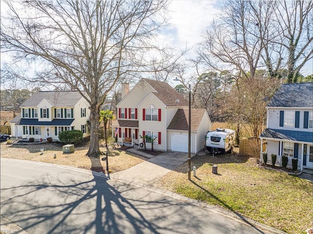 view of front of property featuring a garage, driveway, and a residential view