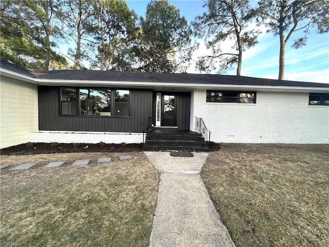 doorway to property featuring brick siding and crawl space