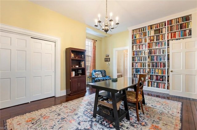 office area featuring a notable chandelier and wood finished floors