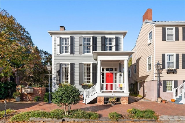 colonial house featuring a chimney