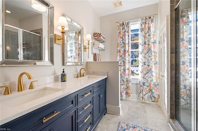 full bathroom with double vanity, a stall shower, visible vents, and a sink