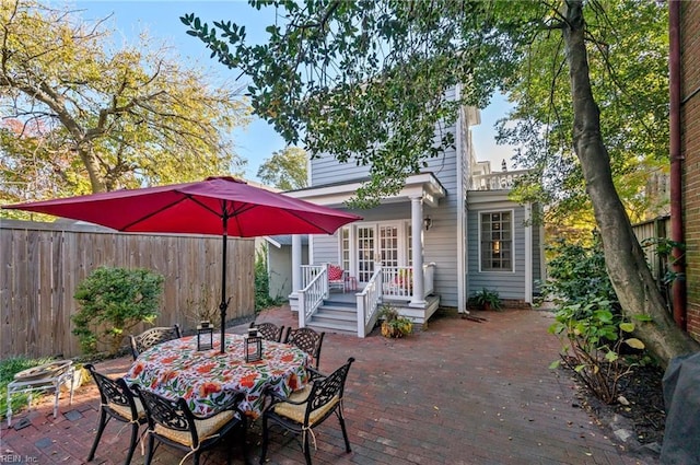 view of patio / terrace featuring outdoor dining area, a fenced backyard, and a wooden deck