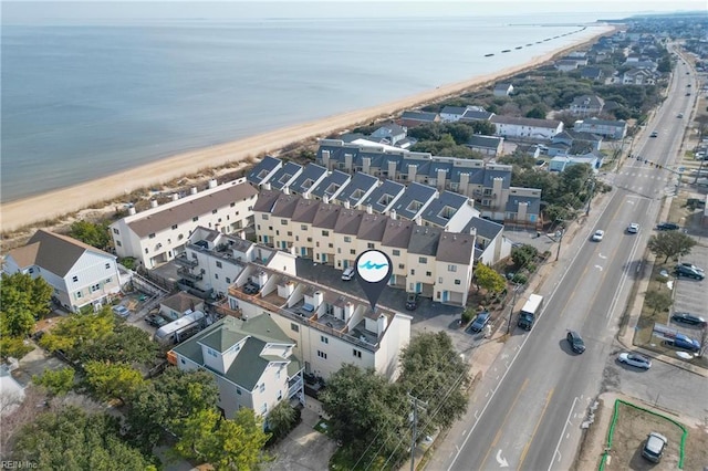 birds eye view of property with a water view, a residential view, and a beach view