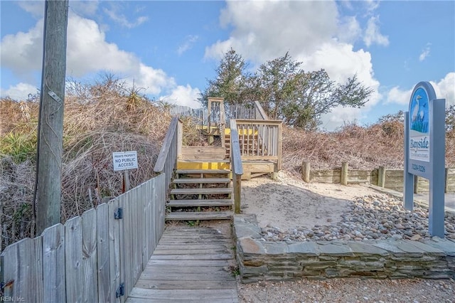 view of play area featuring stairway and a wooden deck