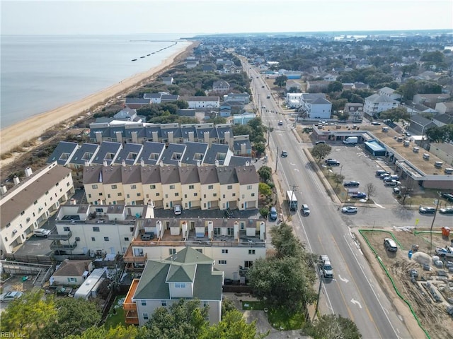 drone / aerial view featuring a water view and a view of the beach