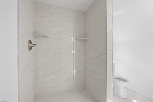 full bath with a marble finish shower and toilet