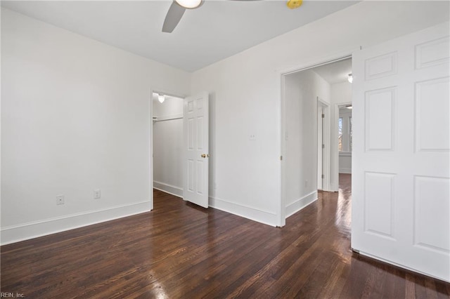 spare room with dark wood-style floors, baseboards, and a ceiling fan