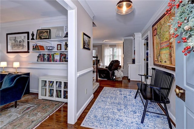 interior space featuring ornamental molding, wood finished floors, and baseboards