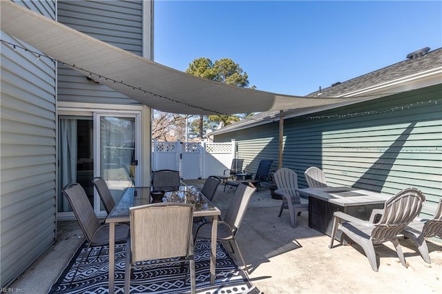 view of patio featuring fence and outdoor dining space