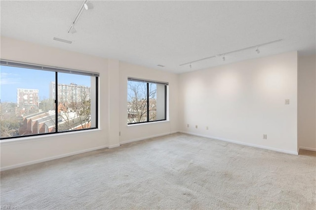 255 College Cross Rd Unit 89, Norfolk, VA 23510 - empty room with a view of city, light colored carpet, visible vents, track lighting, and baseboards