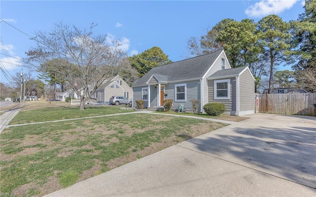 view of front of house with a front yard, fence, and entry steps