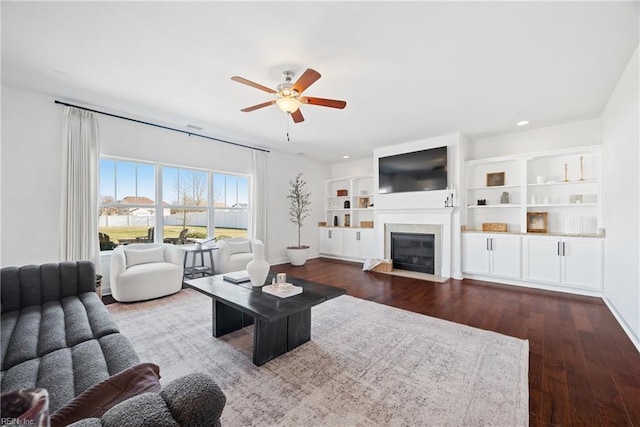 living room with a fireplace with flush hearth, dark wood finished floors, a ceiling fan, and recessed lighting