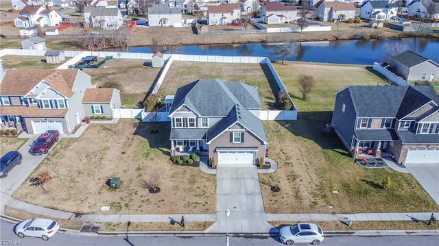 drone / aerial view with a residential view and a water view