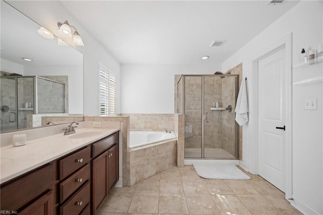 bathroom featuring a garden tub, tile patterned flooring, a shower stall, and vanity