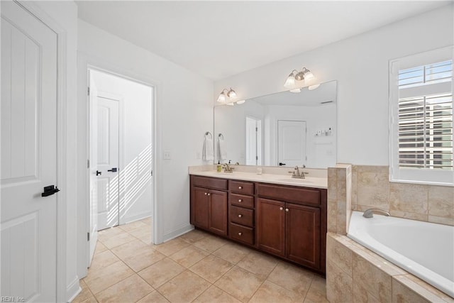 full bath with double vanity, tile patterned flooring, a sink, and a bath