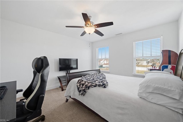 carpeted bedroom with ceiling fan, visible vents, and baseboards