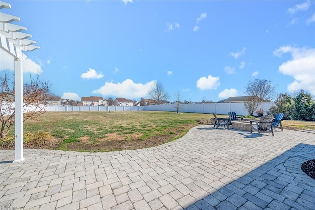 view of patio / terrace featuring fence and a fire pit